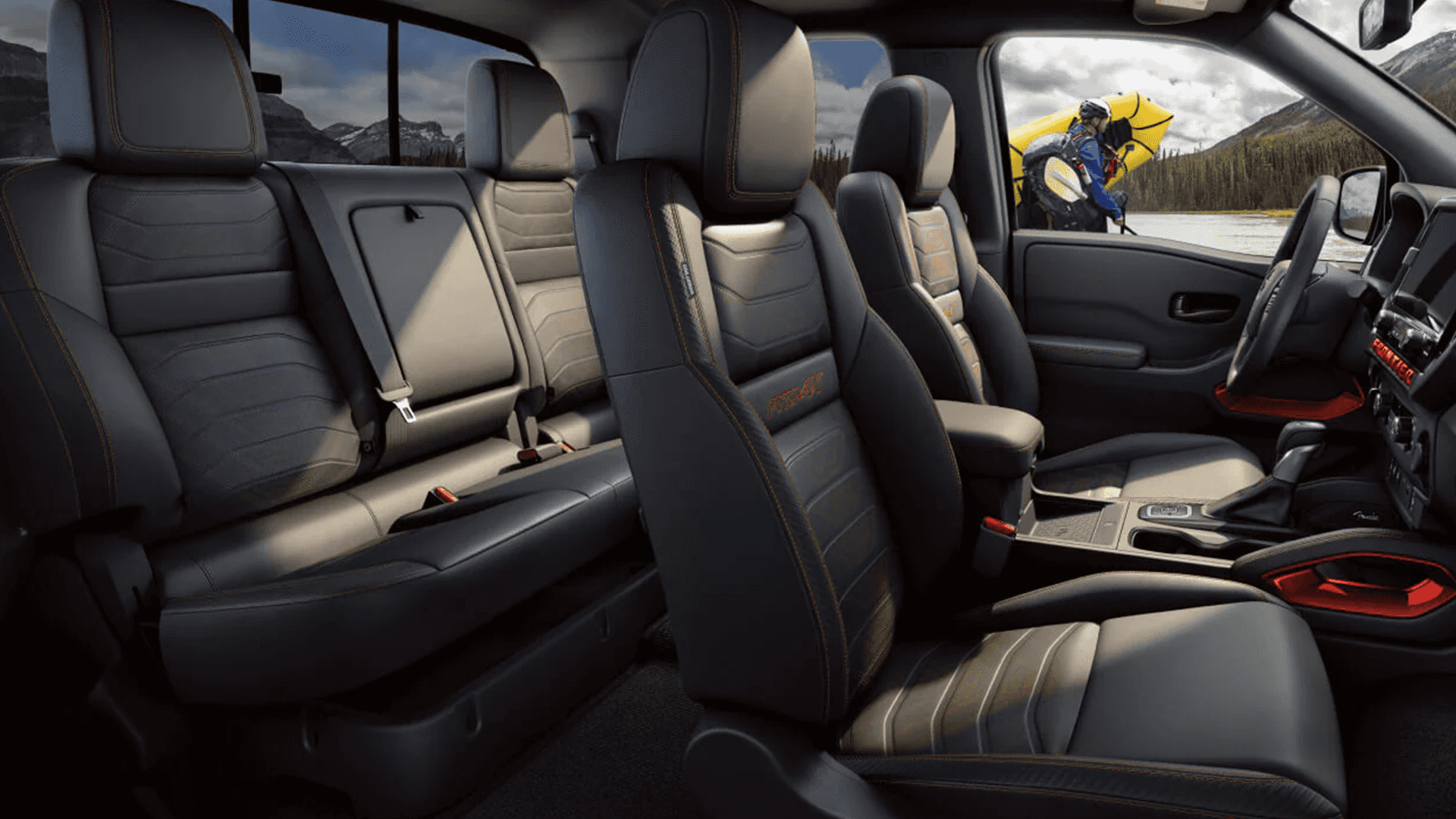 Crew cab interior showing front and rear seats with contrast stitching and center console