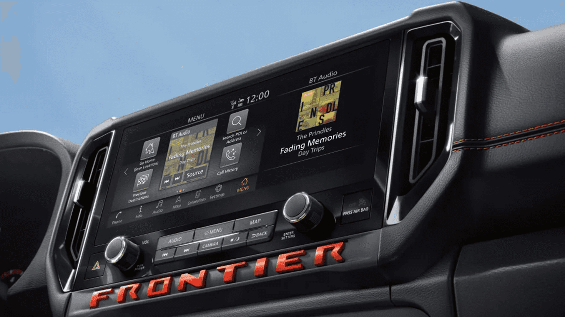 Close up of the center touchscreen showing audio and menu controls on the dash