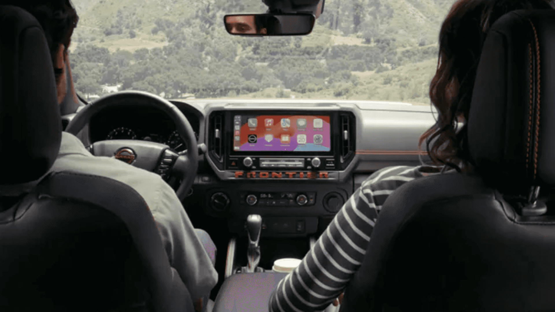 Front seat view of Nissan Frontier interior with touch screen display