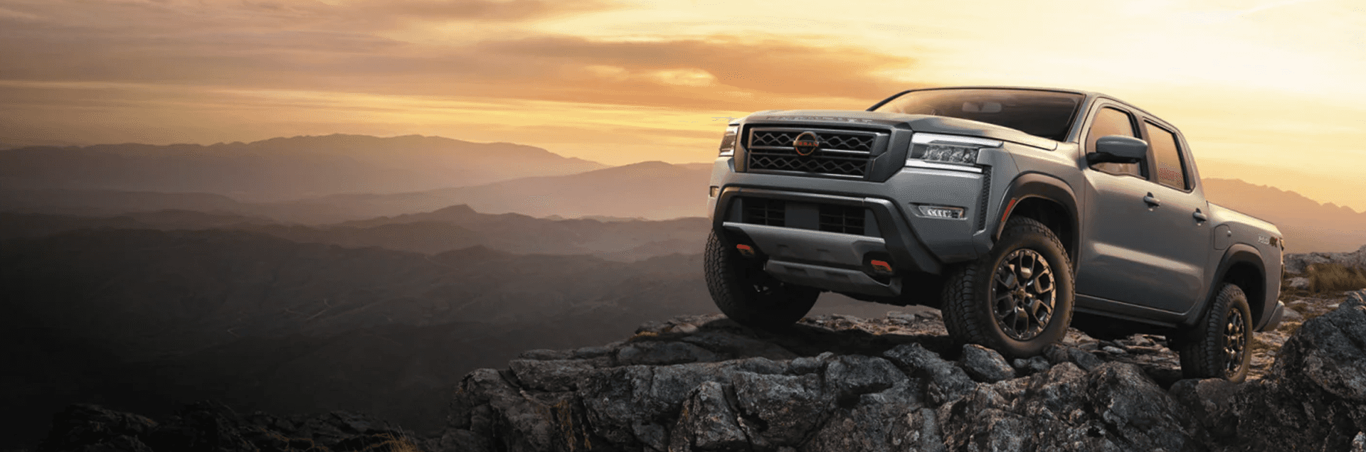 2026 Nissan Frontier pickup truck driving on a dirt road