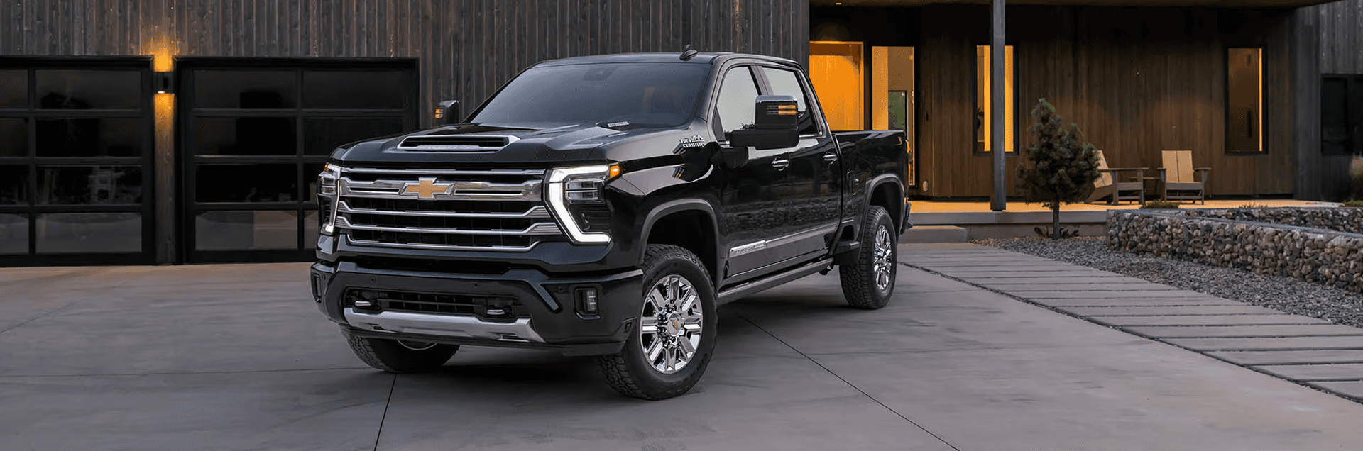 2026 Chevy Silverado 2500 HD heavy duty pickup in front of a modern home