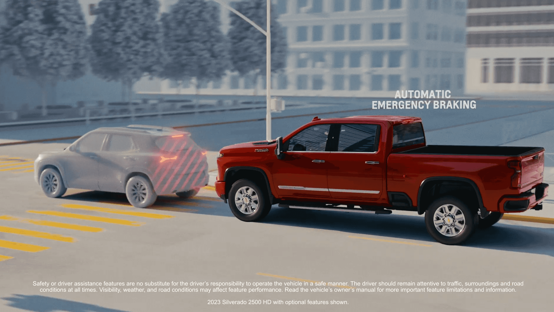 Red Silverado 2500 HD demonstrating Automatic Emergency Braking as it approaches a gray SUV in an urban setting