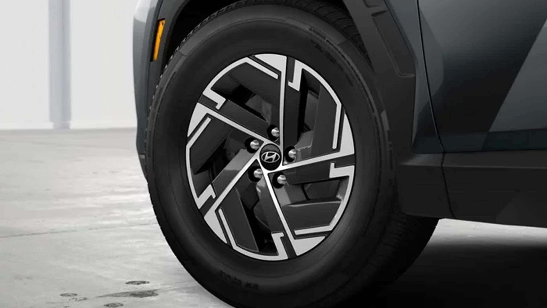 Close-up of Hyundai Tucson Hybrid alloy wheel design, highlighting modern styling and durable tire construction.