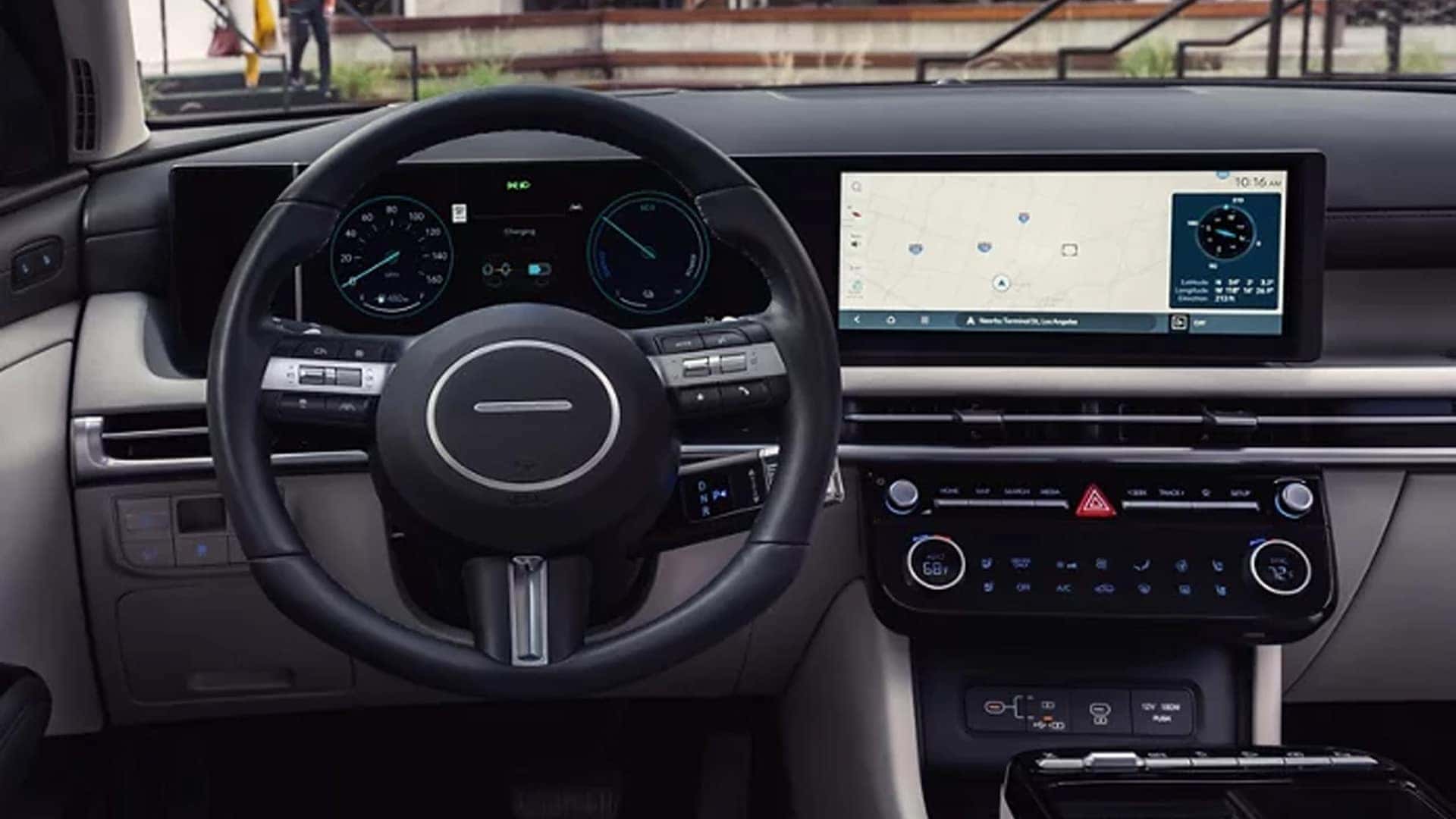Wide digital displays in the Hyundai Tucson Hybrid featuring the instrument cluster and central touchscreen interface.