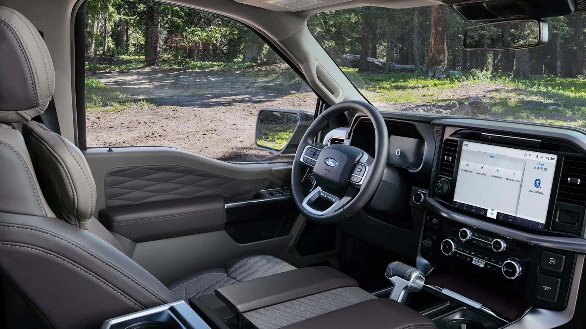 Driver view of the 2026 Ford F-150 interior showing digital instrument cluster, large center touchscreen, and steering wheel controls.