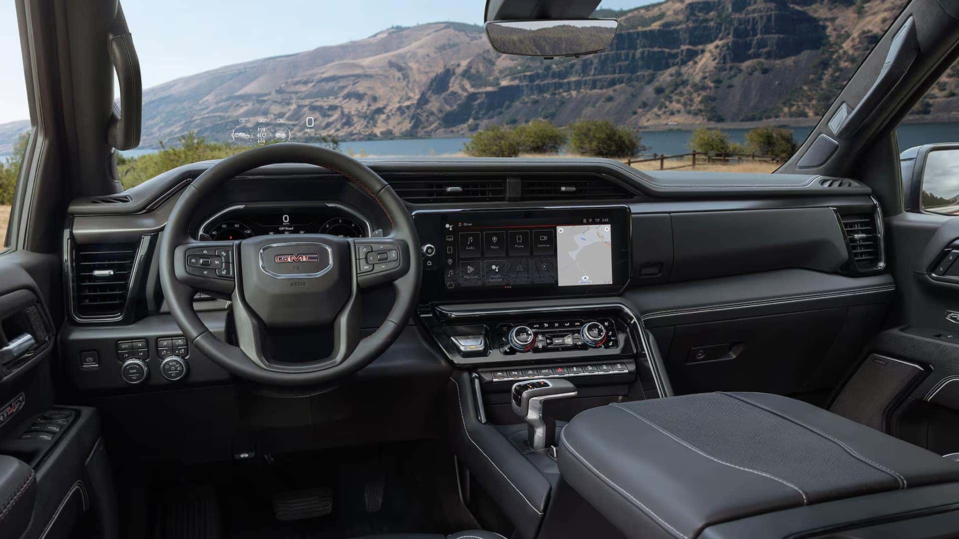 2026 GMC Sierra 1500 driver view showing digital instrument cluster and large infotainment touchscreen