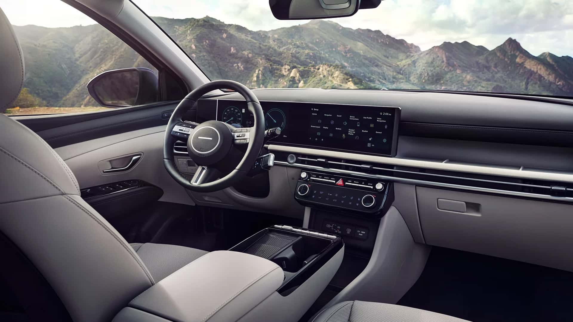 Wide digital instrument cluster and touchscreen display in the Hyundai Tucson Hybrid, showing infotainment and vehicle information.