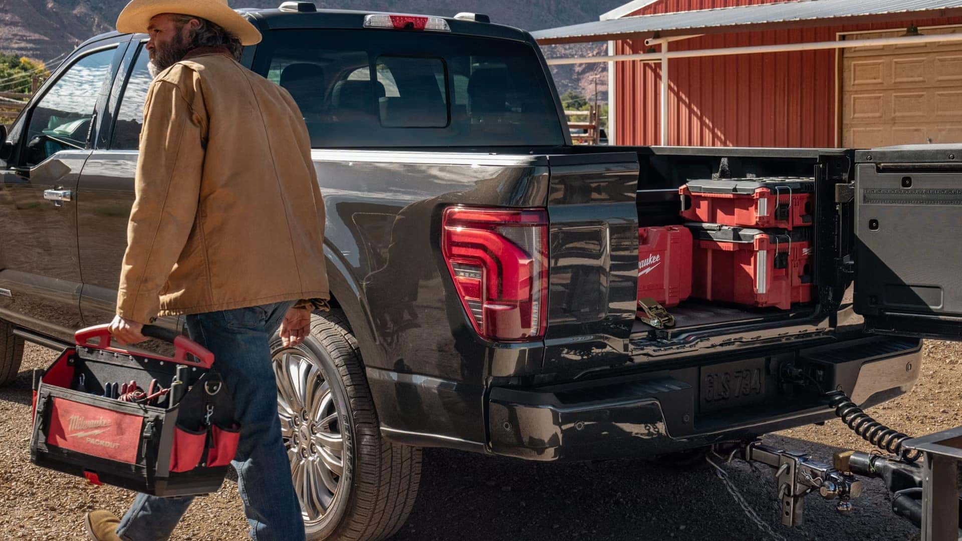 2026 Ford F-150 cargo bed with tailgate open, showing organized tool storage and bed utility features designed for work use.