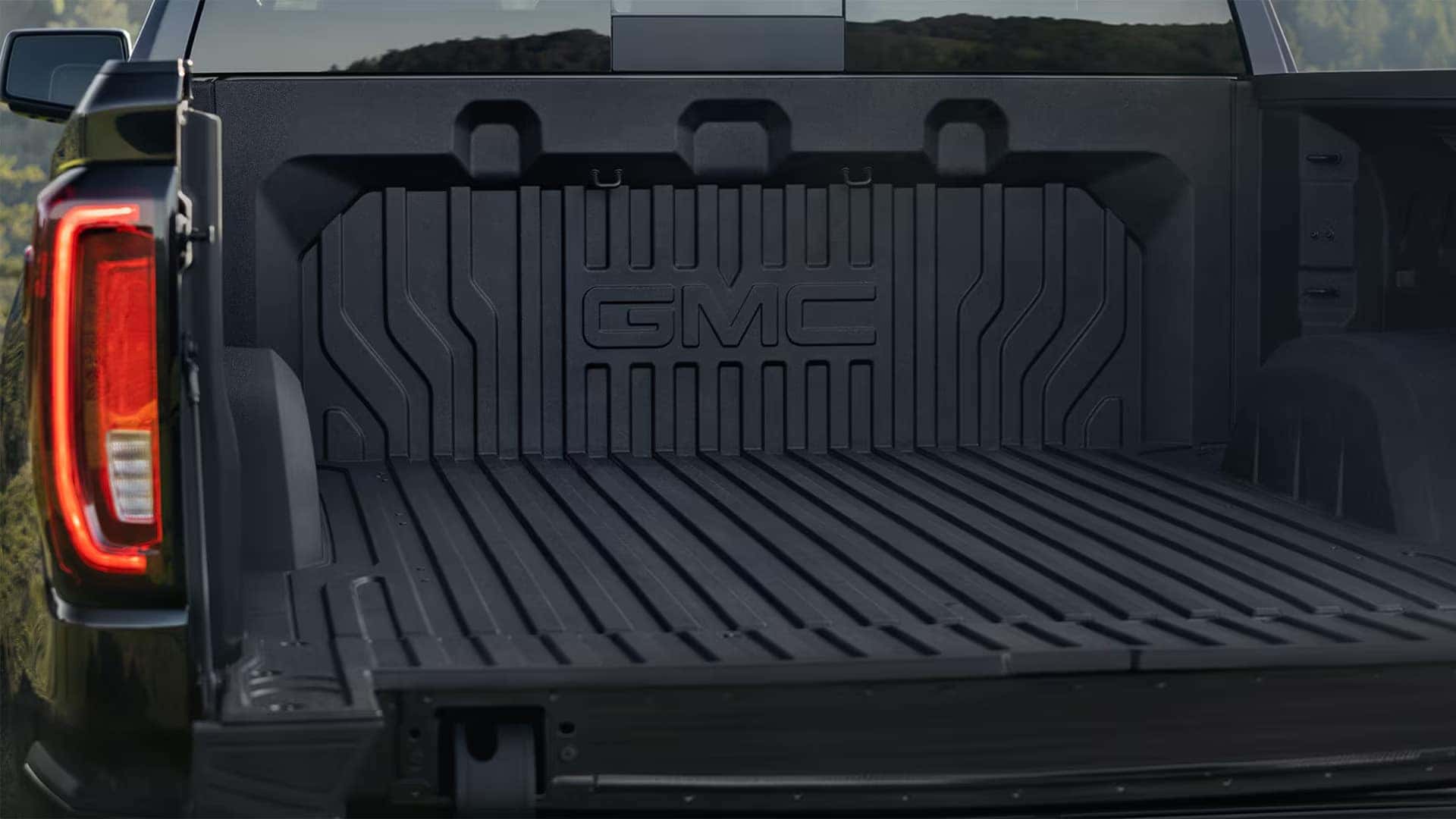 GMC Sierra 1500 cargo bed with durable bed liner and spacious truck bed design for hauling gear.