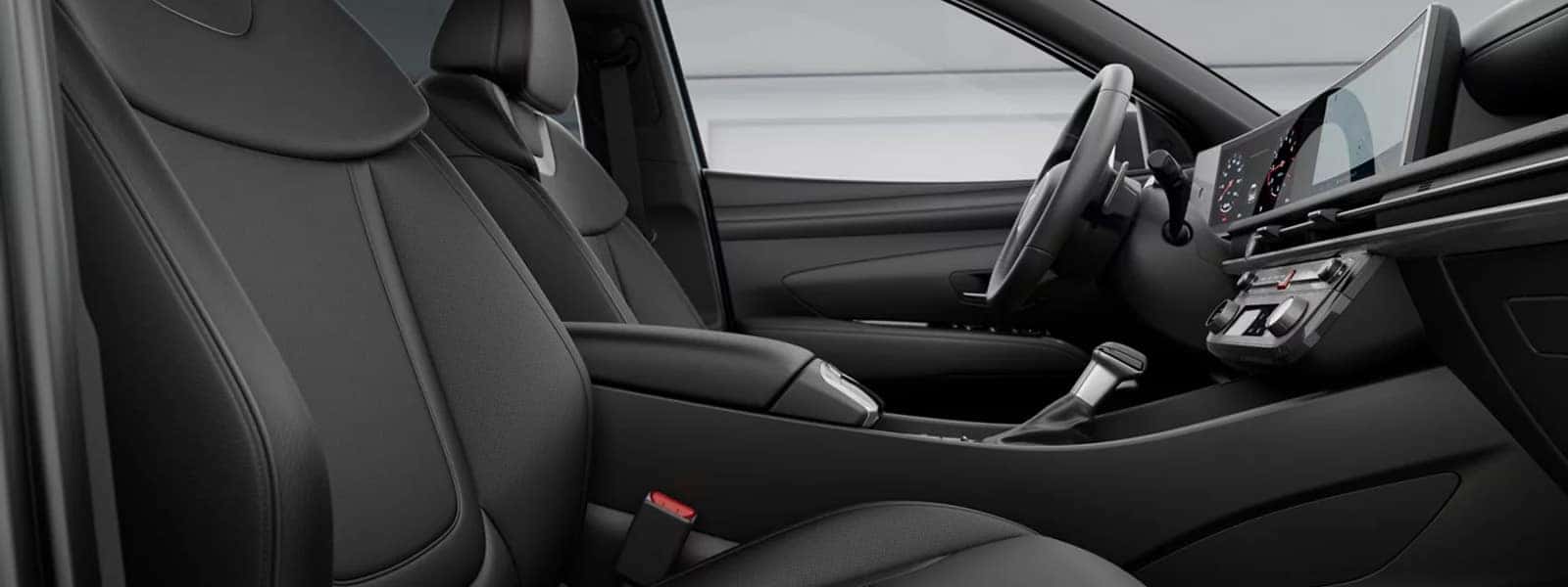 2026 Hyundai Santa Cruz interior with front seats, center console, and wide dashboard display in a black cabin