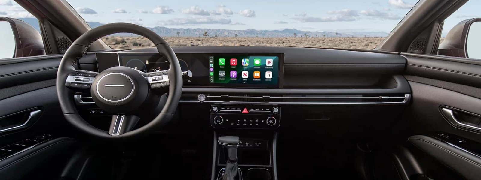 Interior view of the 2026 Hyundai Santa Cruz featuring a wide digital display, infotainment screen, steering wheel controls, and modern dashboard design