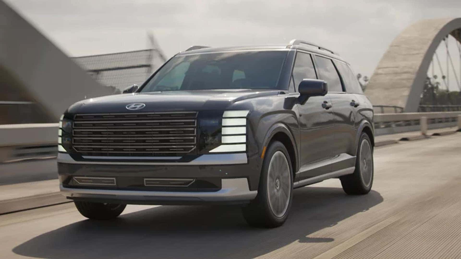 Exterior view of the 2026 Hyundai Palisade Hybrid showcasing its bold front grille, LED headlights, and three-row SUV design