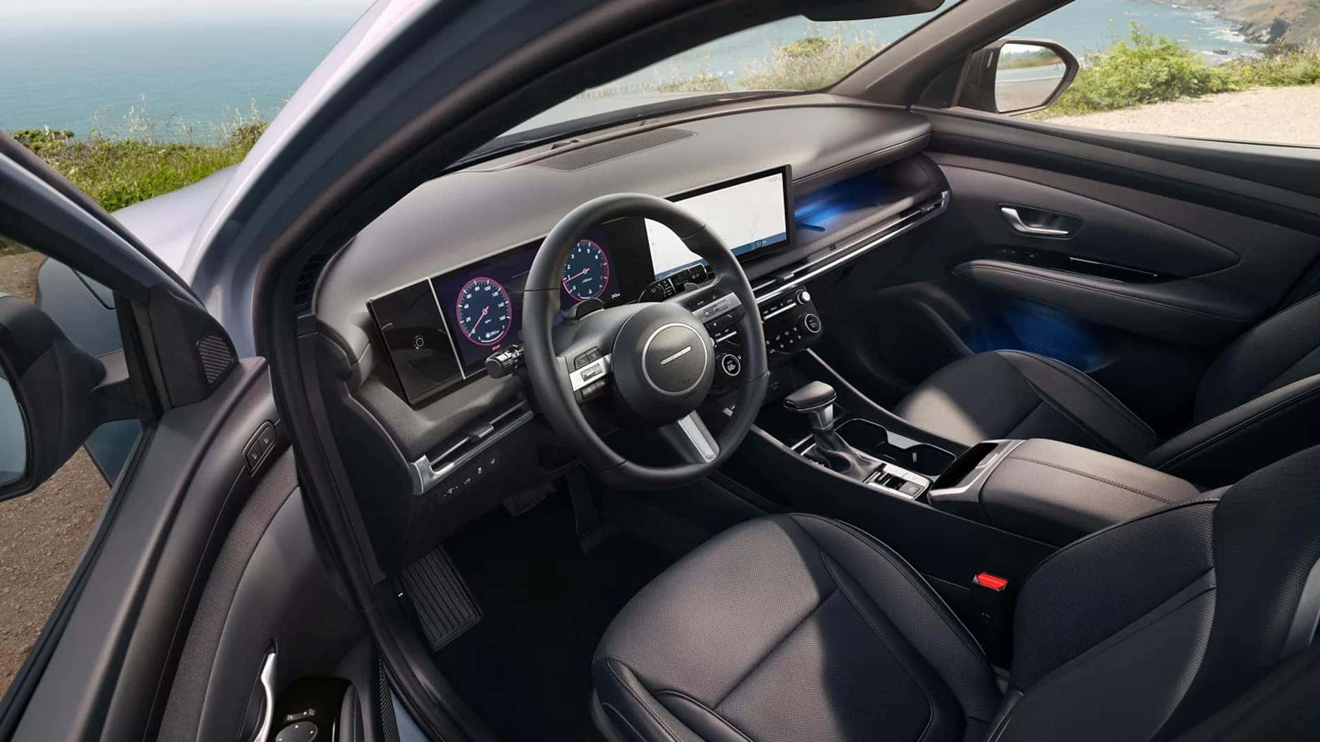 Driver view of the 2026 Hyundai Santa Cruz interior showing steering wheel, digital gauge cluster, and center touchscreen