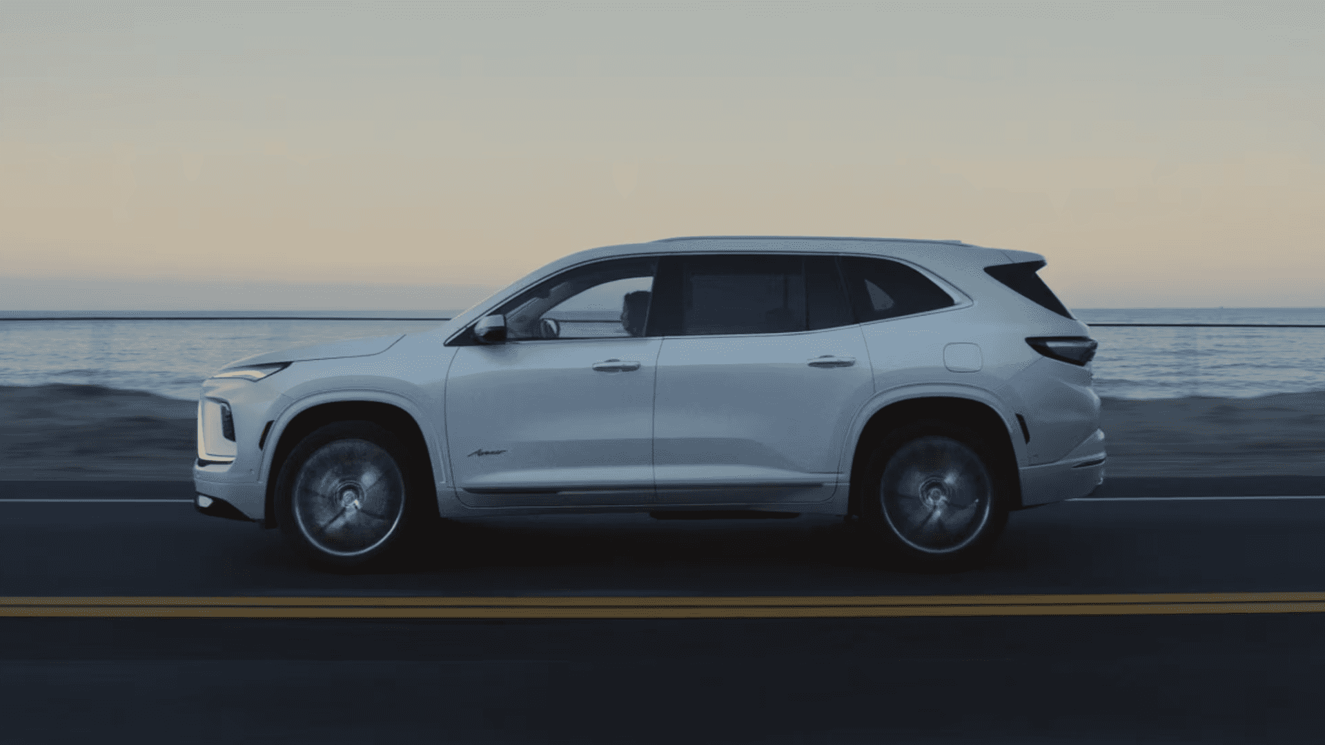 2026 Buick Enclave side profile in motion highlighting performance design