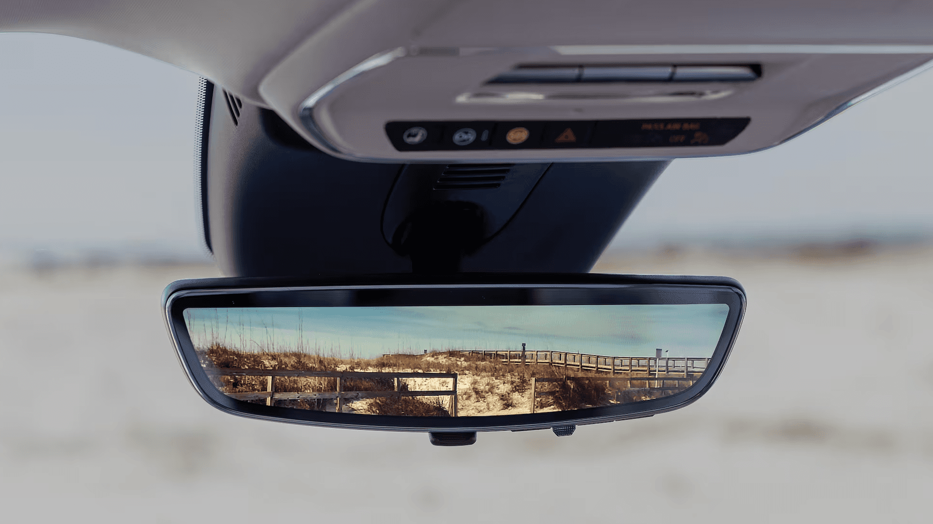 2026 Buick Enclave rearview mirror camera display showing road behind the vehicle