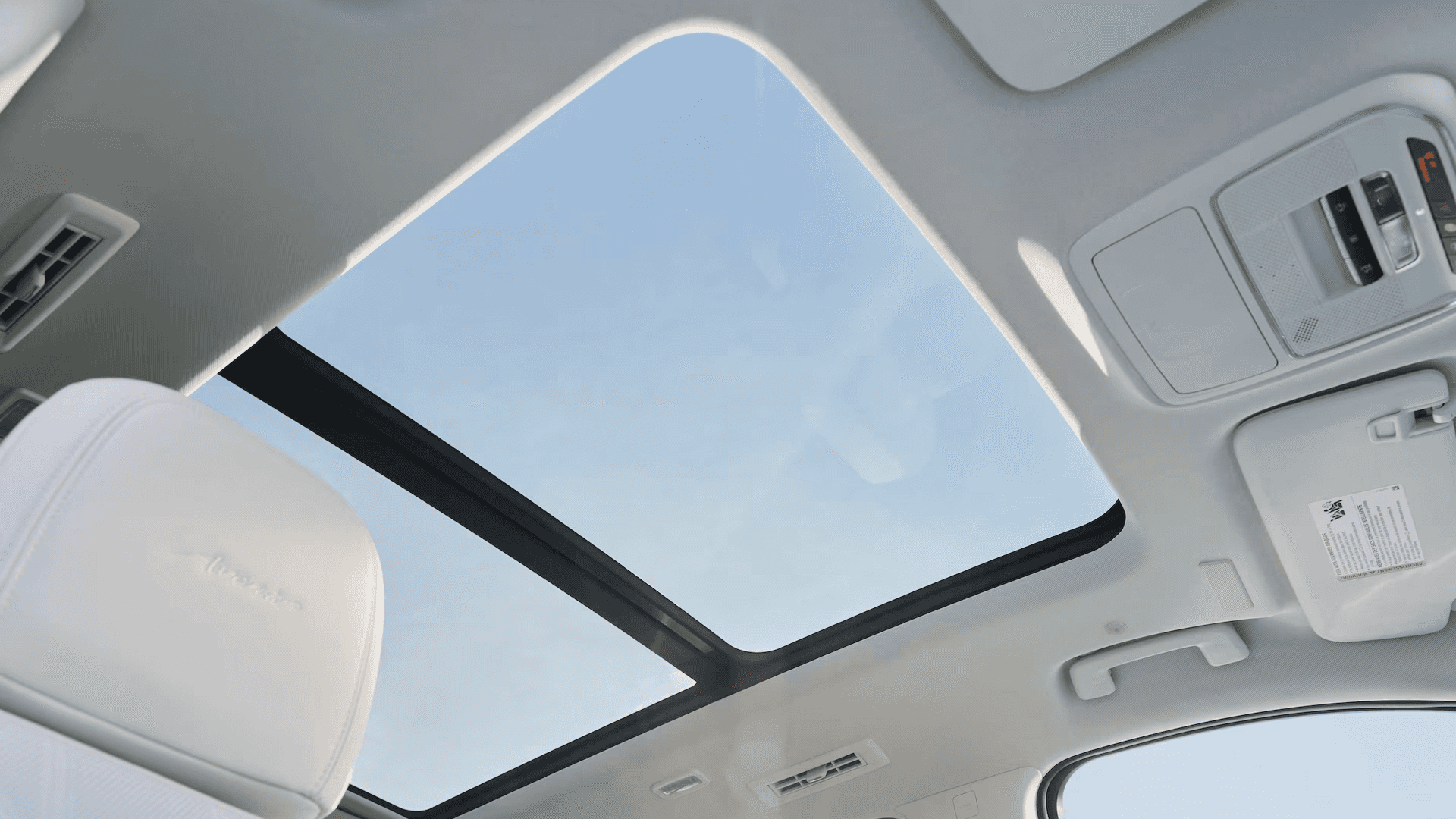 Open panoramic sunroof view from inside the 2026 Buick Enclave cabin