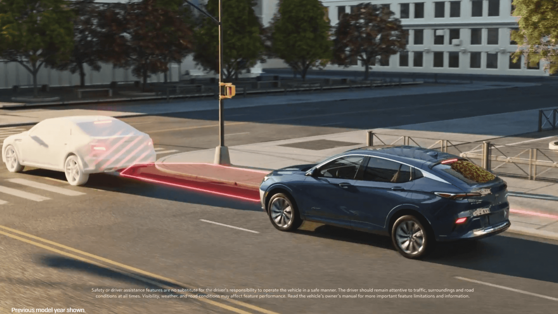 Blue Buick Envista driving in the right lane behind a vehicle ahead, with a red highlighted detection and braking zone graphic illustrating forward collision and braking support.