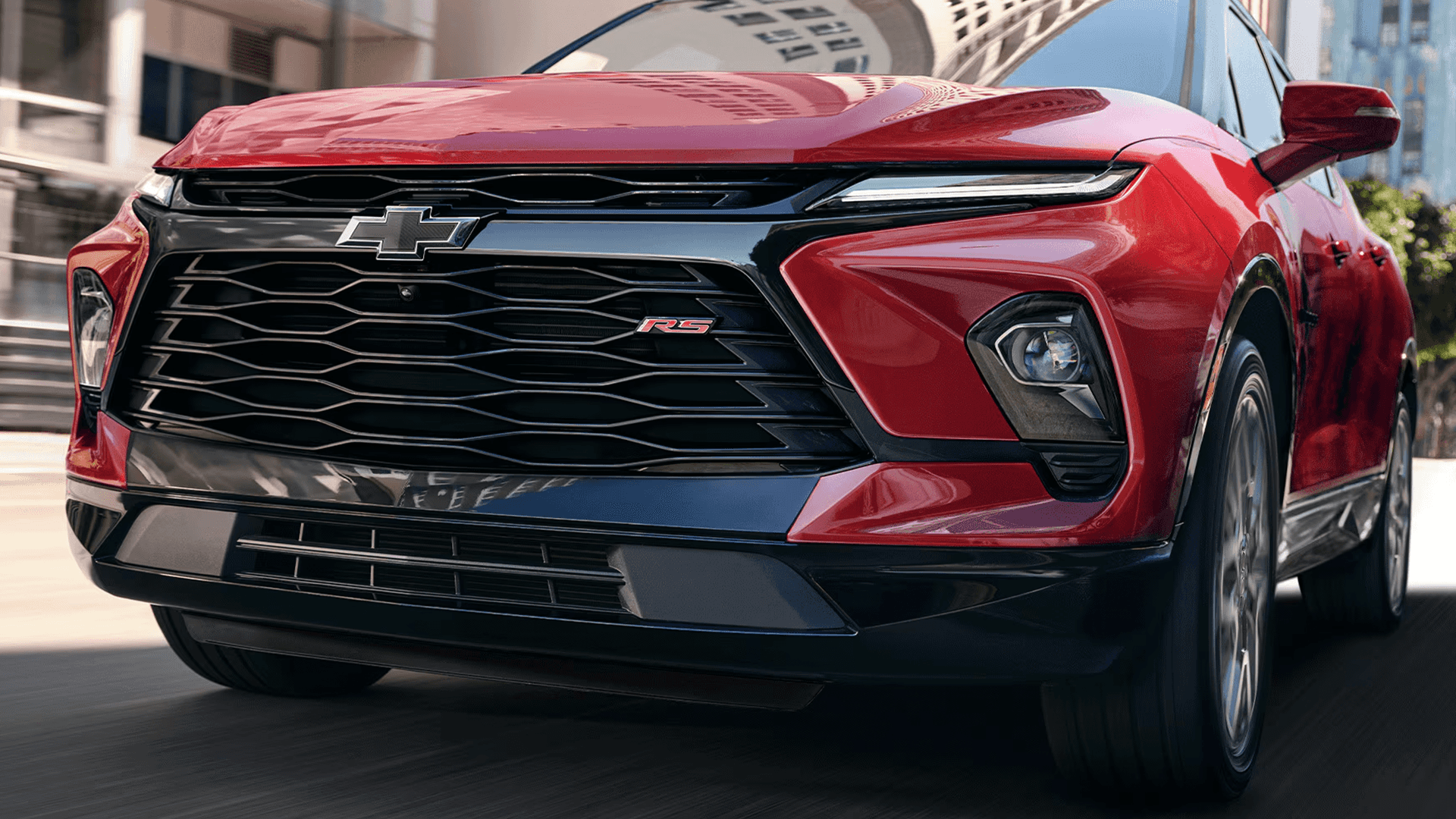 Front view of a red 2026 Chevy Blazer showing grille, LED lighting, and RS badge