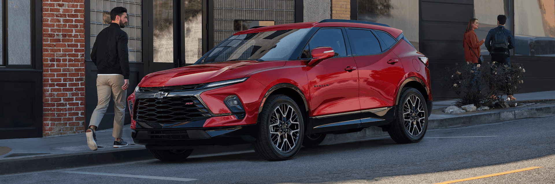 Red 2026 Chevy Blazer parked along a city street near storefronts