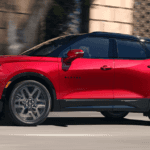 2026 Chevy Blazer driving town an urban street setting