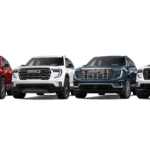 Row of four 2026 GMC Acadia SUVs on a white background, showing different trims and front fascia styles in red, white, blue, and white, with varied grille designs and wheel finishes.