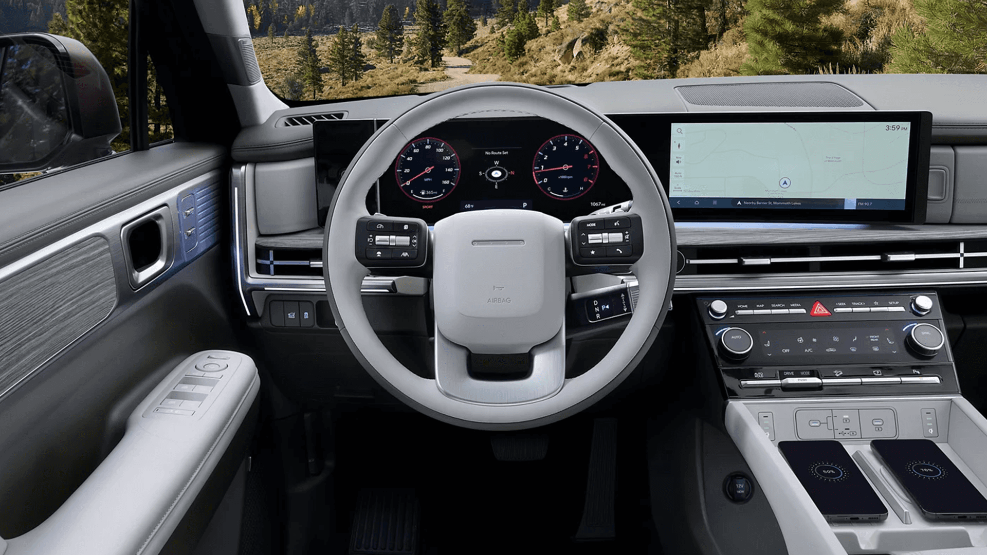 Driver cockpit view of a 2026 Hyundai Santa Fe Hybrid showing a light colored steering wheel, digital gauge cluster, wide infotainment screen with map navigation, slim dashboard vents, climate controls, and two wireless charging pads on the center console.