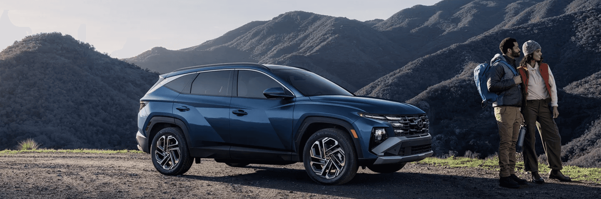 Front three-quarter view of a 2026 Hyundai Tucson parked outdoors, showing the SUV profile, grille styling, LED lighting signature, and alloy wheels.