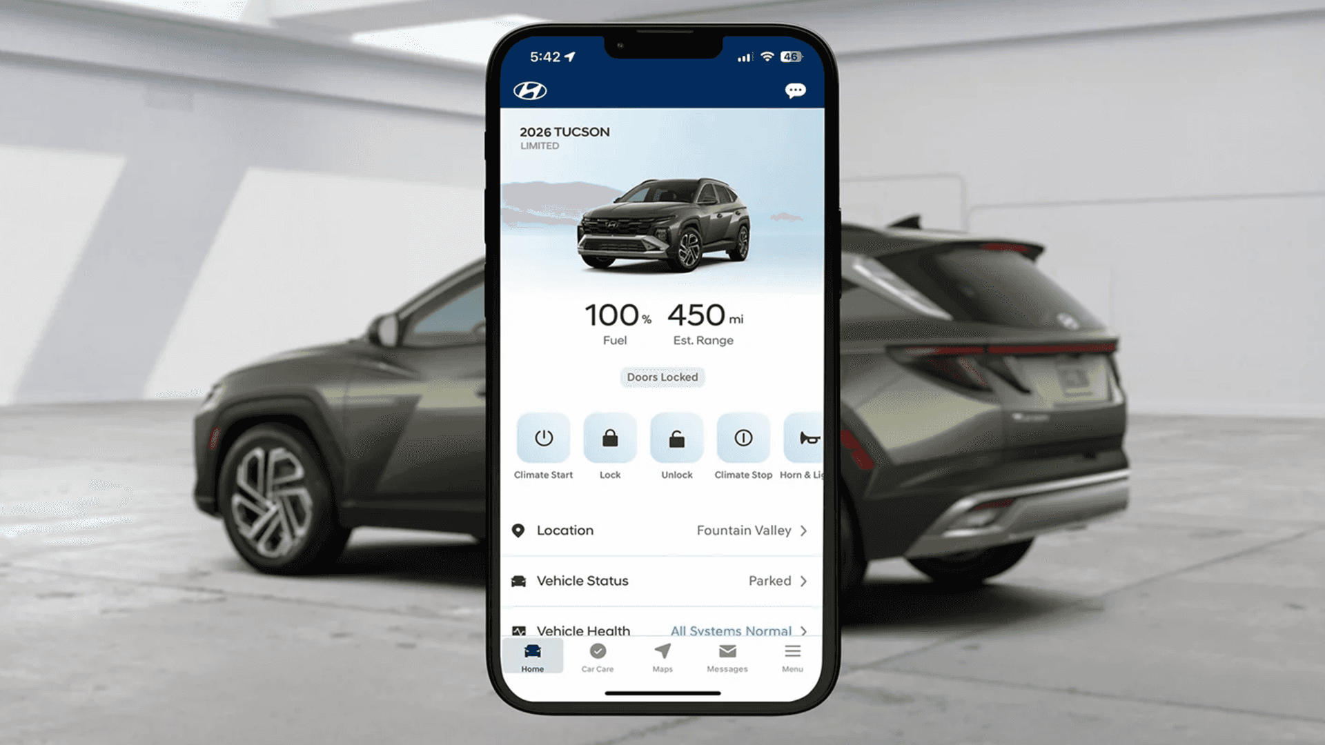 Smartphone displaying the MyHyundai app home screen with a 2026 Tucson and remote controls like climate start, lock, and unlock, in front of a Tucson parked in a studio.