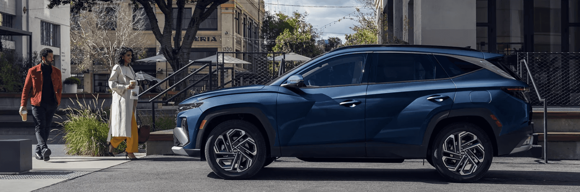 Blue Hyundai Tucson SUV driving on a city road