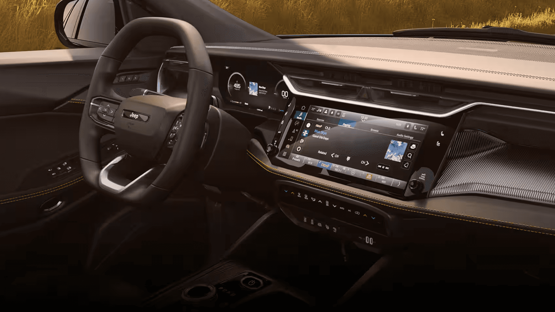 Angled view of the 2026 Jeep Cherokee dashboard with a large touchscreen, digital instrument display, and steering wheel.