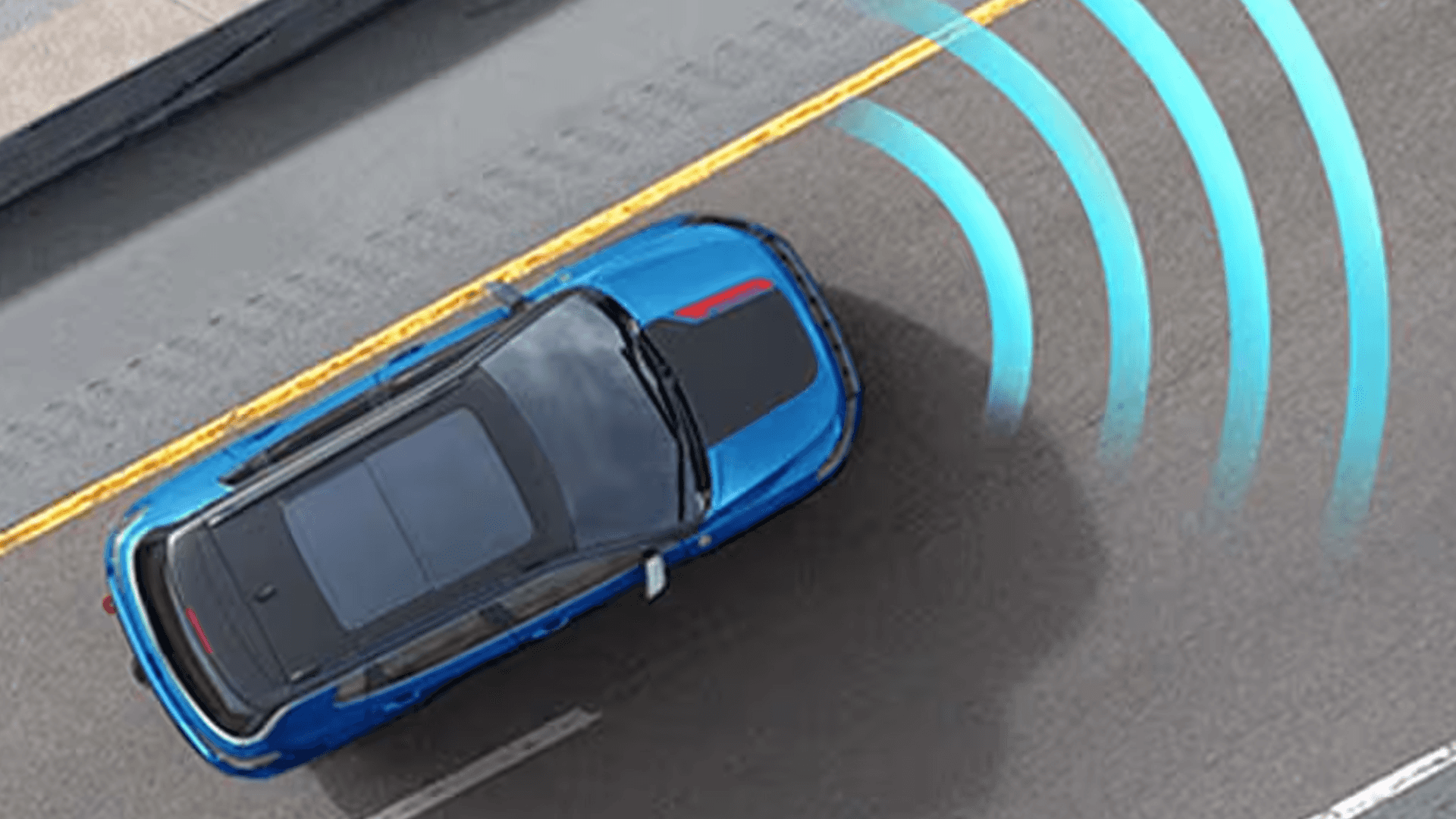 Overhead view of a blue SUV with forward sensing graphics on a roadway.