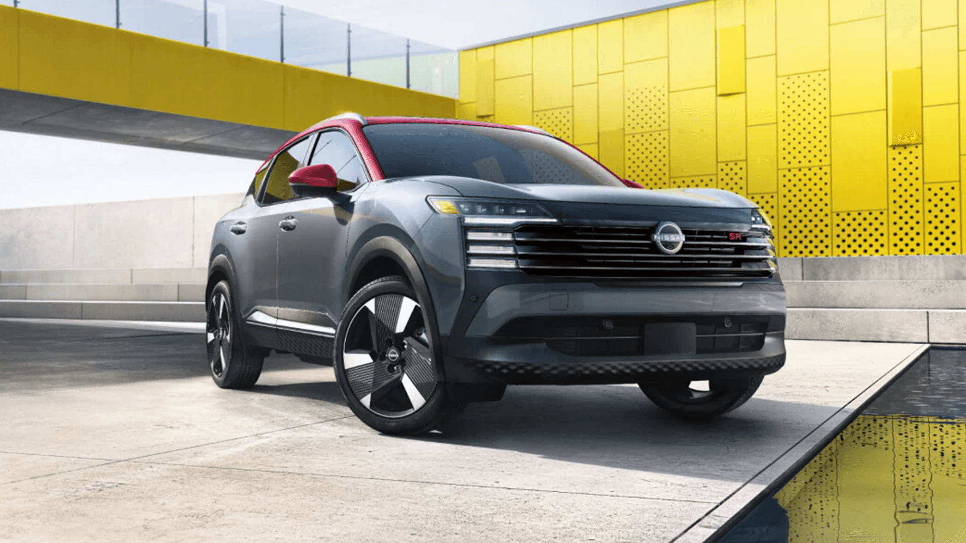 2026 Nissan Kicks parked in an urban setting showing bold front design and grille