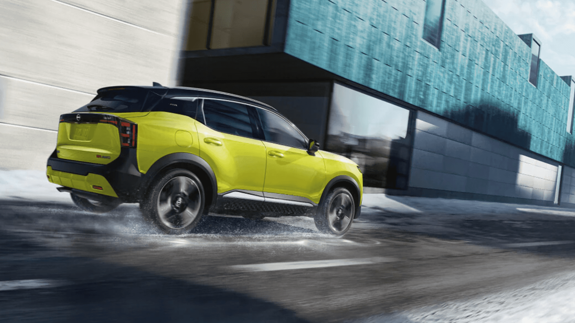 2026 Nissan Kicks driving on a wet road demonstrating available all wheel drive