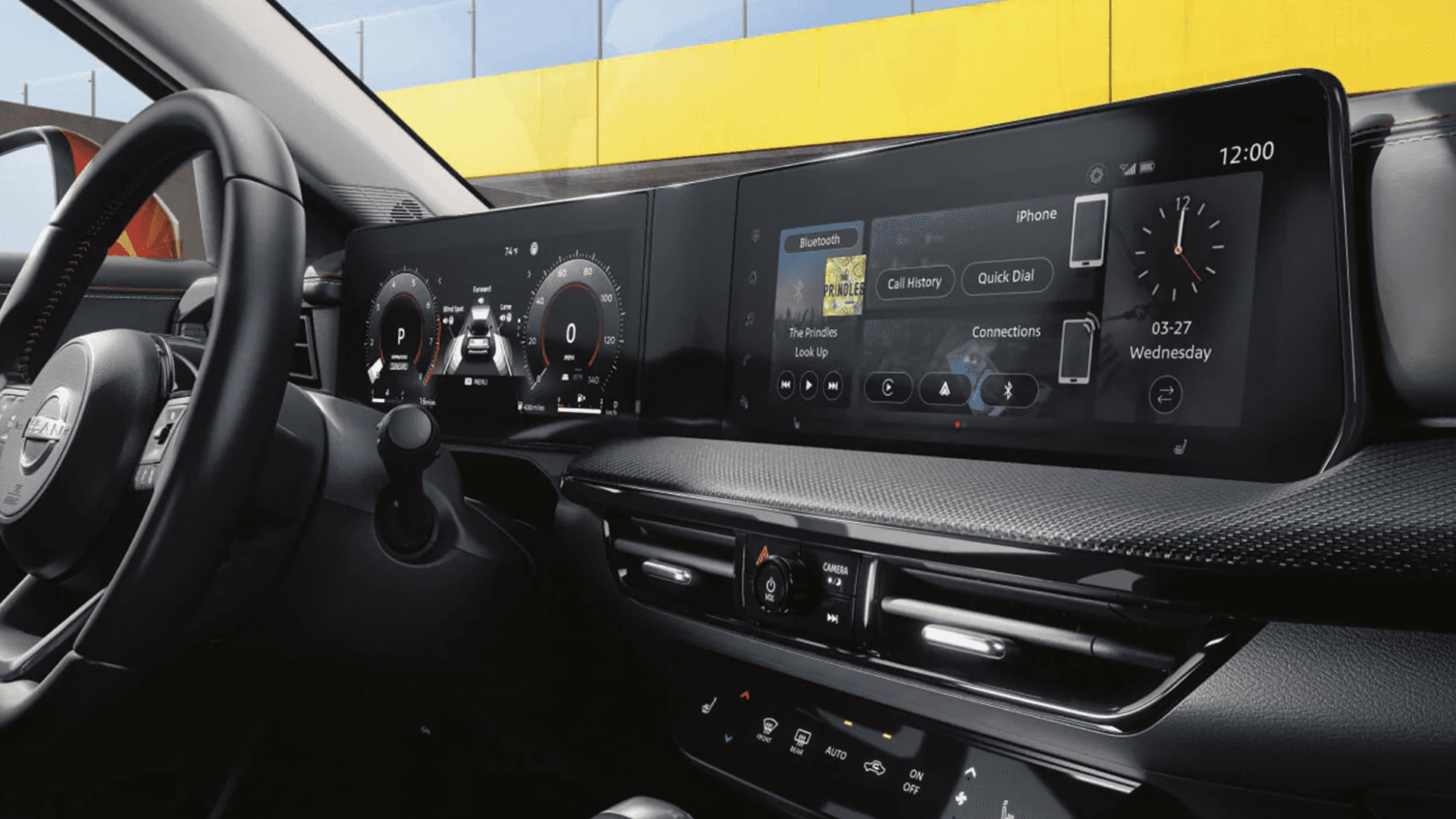 2026 Nissan Kicks driver area showing the steering wheel and a wide dashboard display setup with digital gauges and an infotainment screen displaying phone and media controls