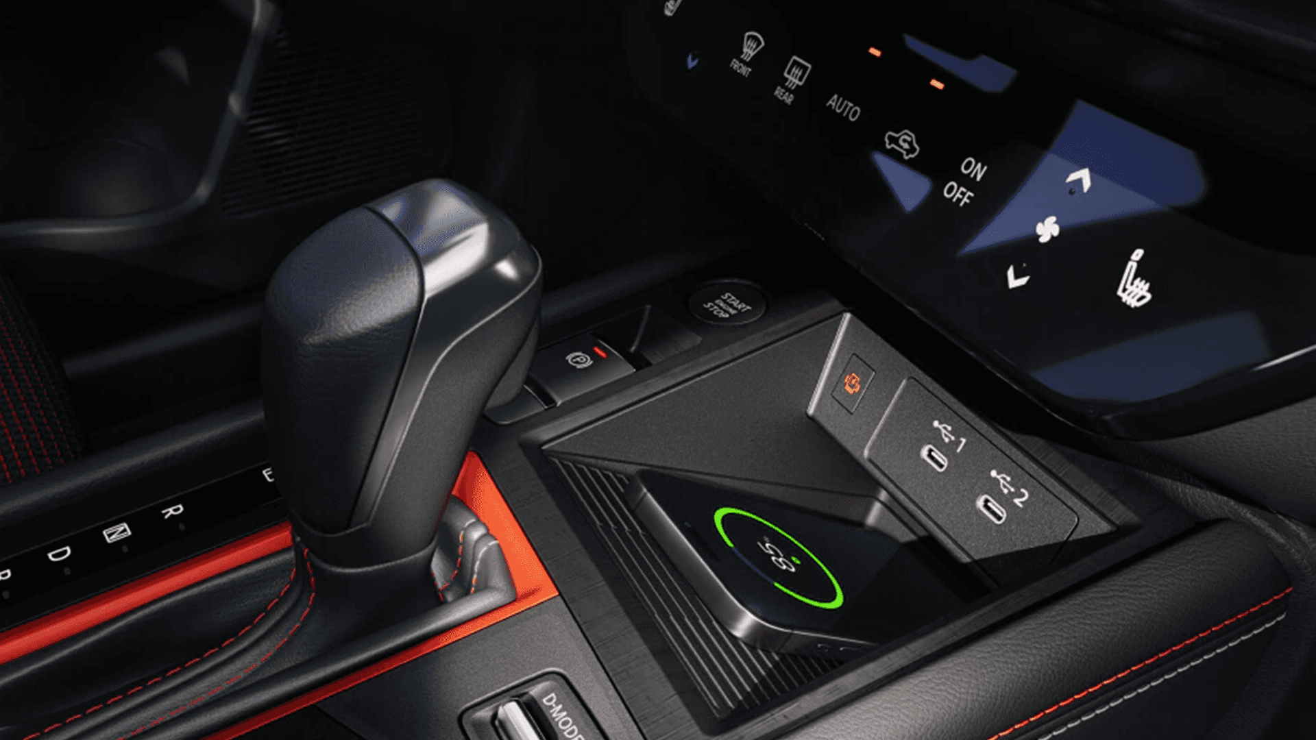 Center console with wireless charging pad, USB-C ports, and climate control touch panel in the 2026 Nissan Kicks