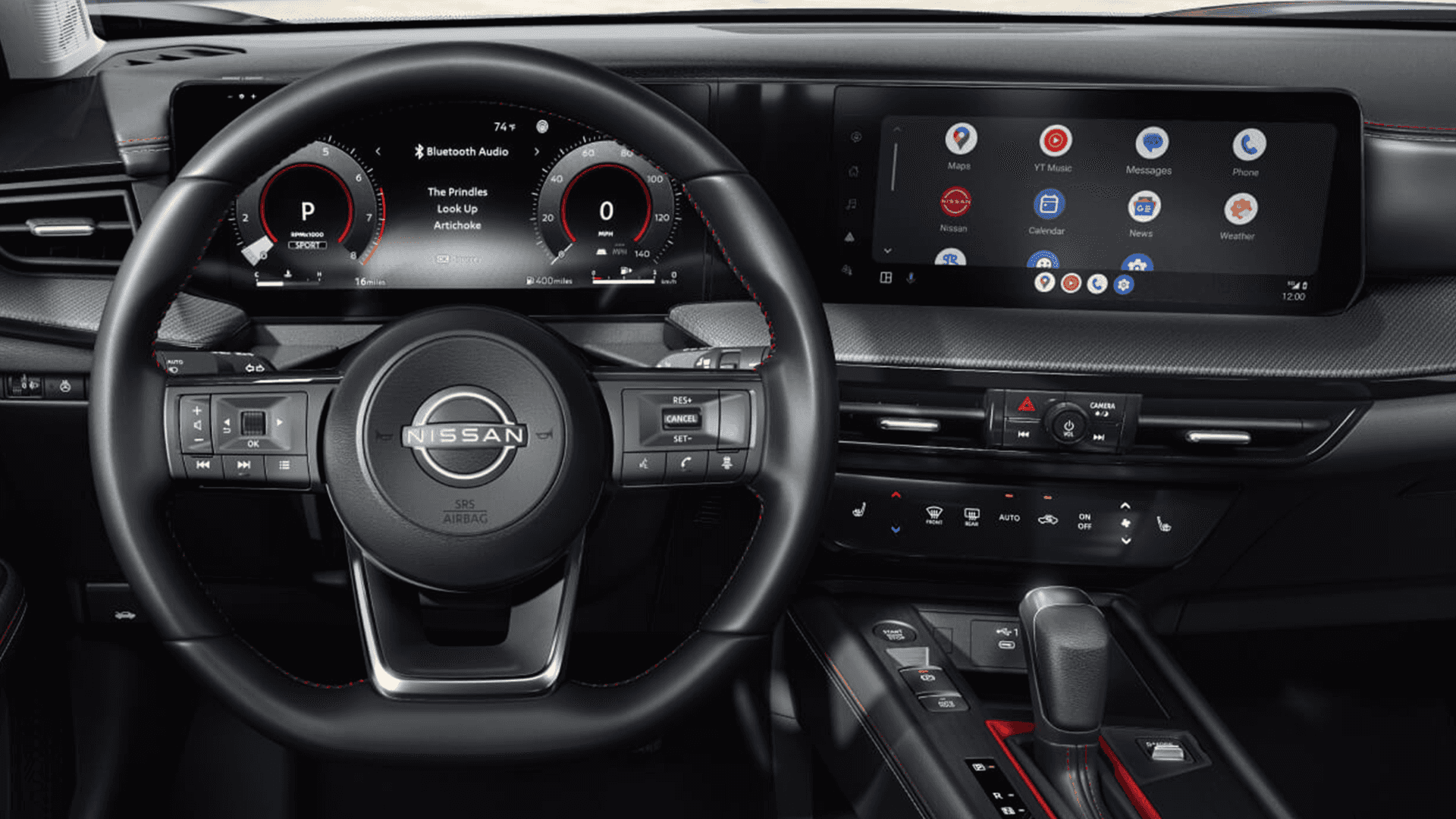 Steering wheel and dual displays in the 2026 Nissan Kicks showing audio and Android Auto app icons