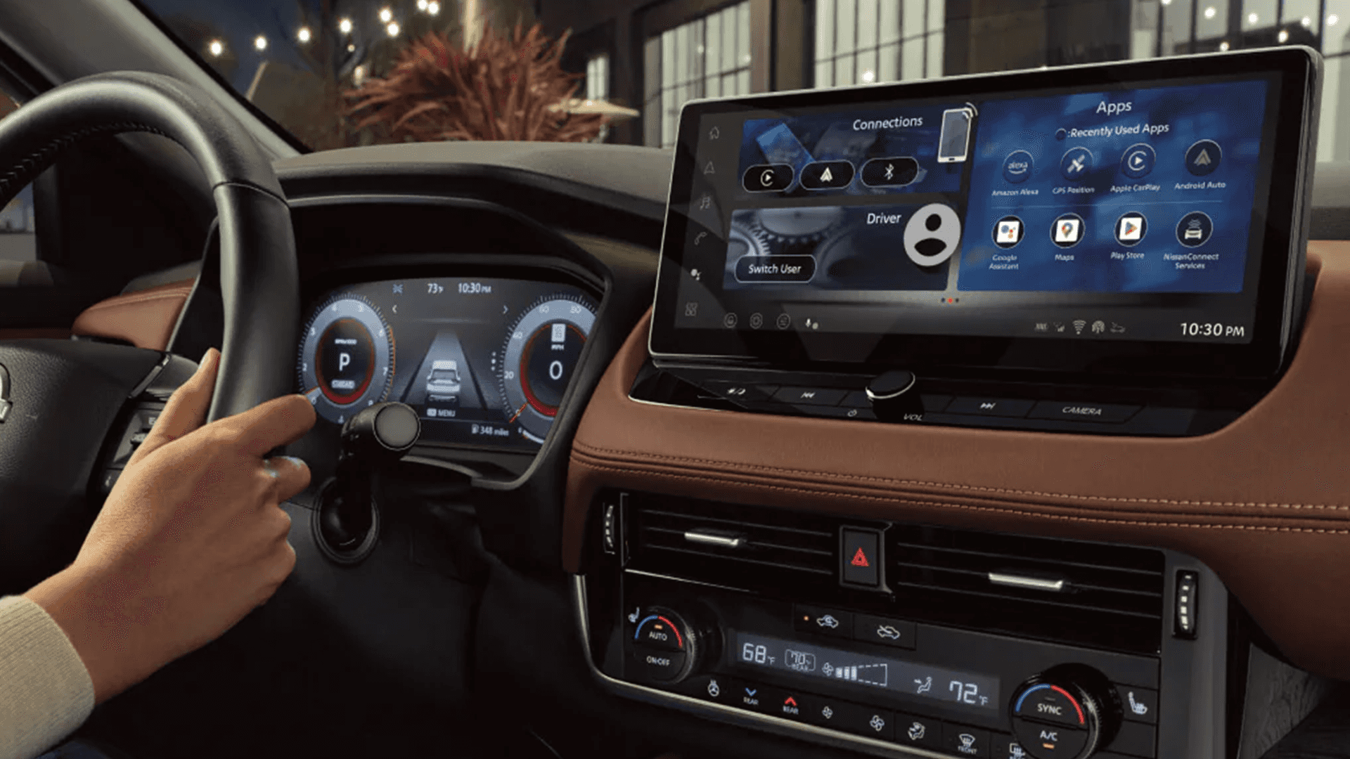 Driver view of the digital gauge cluster and wide center infotainment display showing app icons and connections