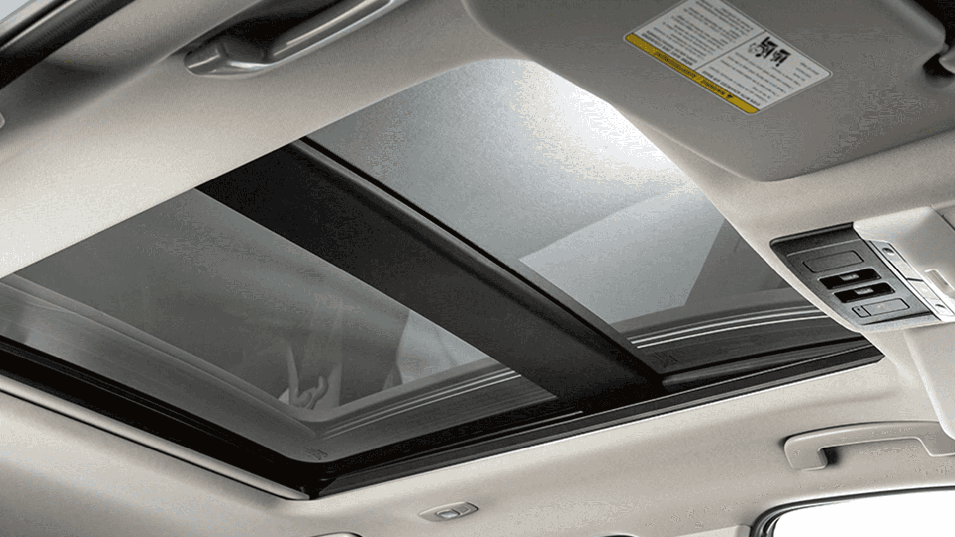 Panoramic moonroof view from inside the 2026 Nissan Rogue with overhead controls