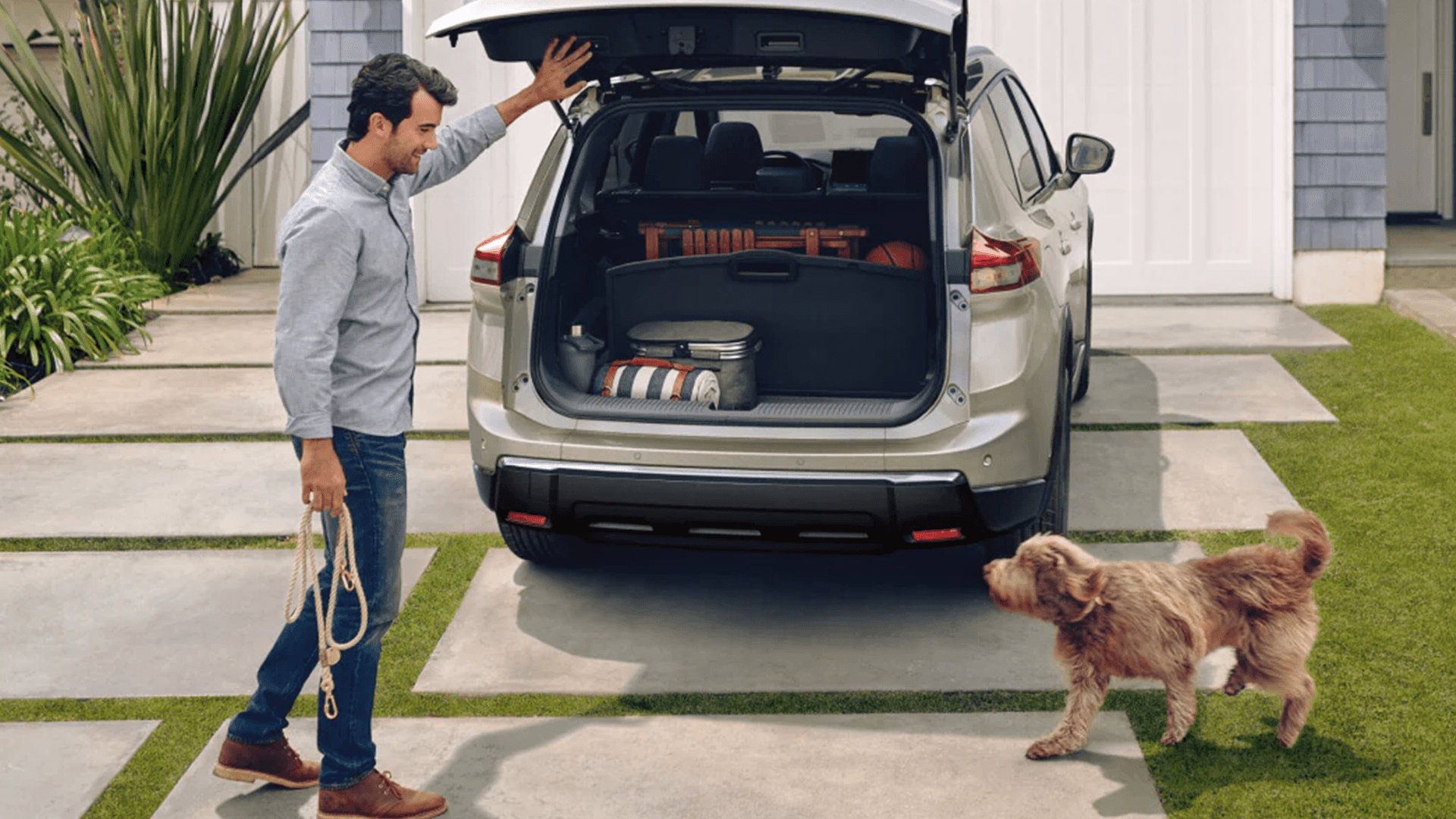 2026 Nissan Rogue rear cargo area with liftgate open and gear loaded inside