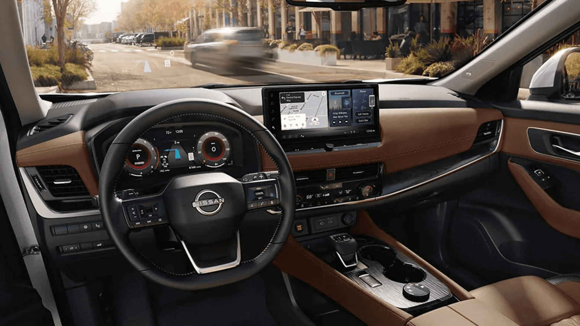 Wide interior view of a Nissan Rogue cabin with center touchscreen, digital gauges, and steering wheel