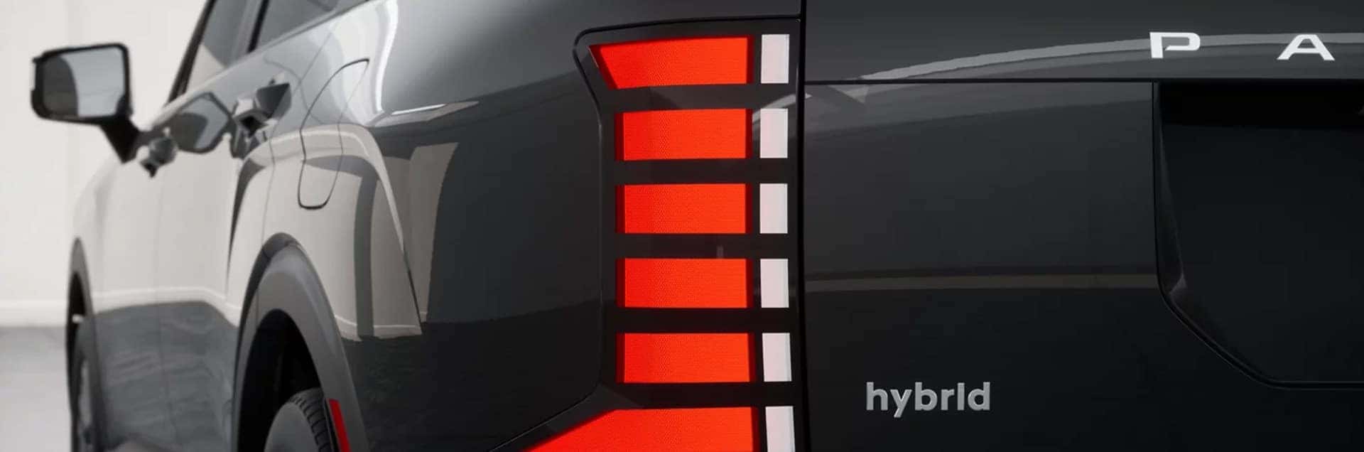 2026 Hyundai Palisade Hybrid rear exterior close up showing LED taillight design and hybrid badge