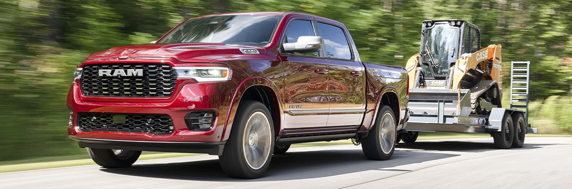 2026 RAM 1500 towing a construction equipment trailer on a highway, showcasing towing and hauling capability