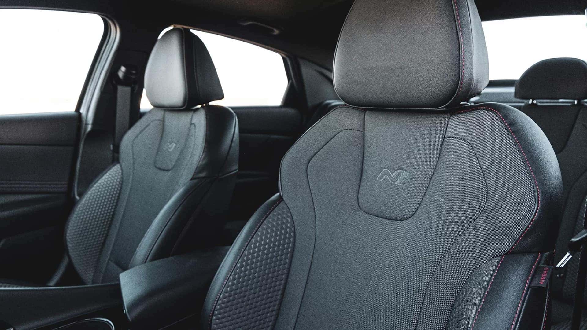 2026 Hyundai Elantra front seats with sport styled cloth upholstery, headrests, and visible interior stitching details