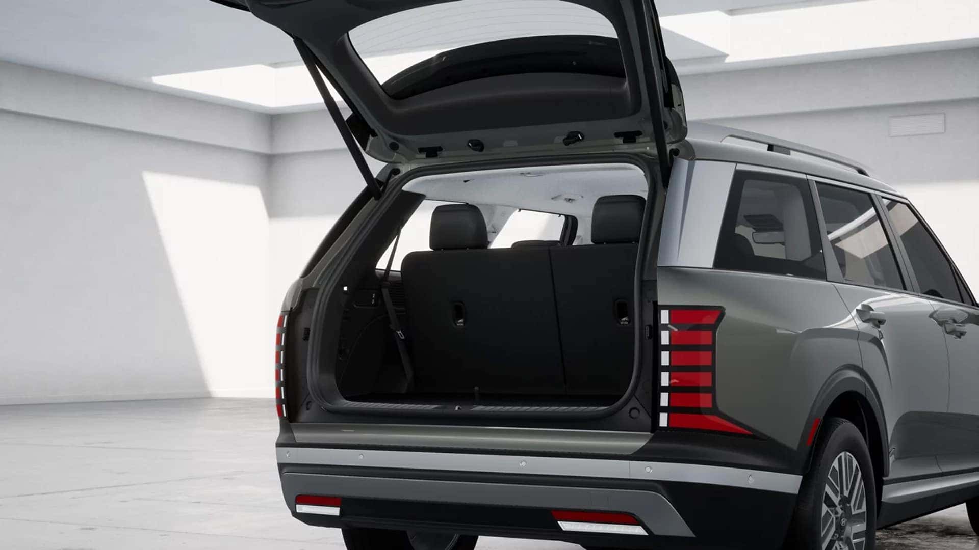 2026 Hyundai Palisade Hybrid rear exterior with liftgate open highlighting cargo access and vertical LED taillight design