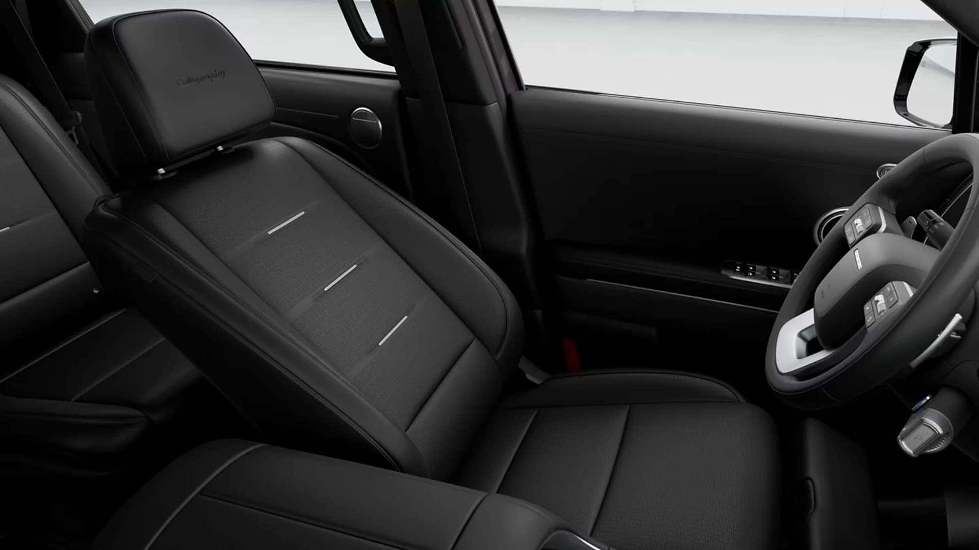 2026 Hyundai Palisade Hybrid interior showing front seats with premium upholstery, center console, and panoramic sunroof