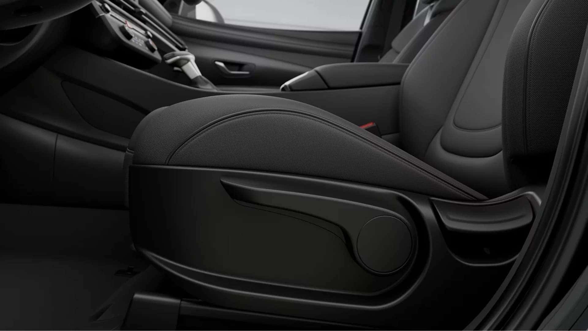 Close view of the 2026 Hyundai Santa Cruz front seat with textured upholstery and seat adjustment controls