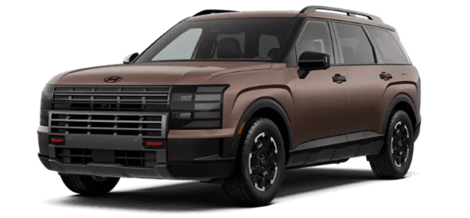 Bronze 2026 Hyundai Palisade XRT PRO SUV shown in a front three quarter view on a transparent background, with a blacked out rugged front fascia, dark grille and lighting surround, chunky black lower cladding, black alloy wheels, all terrain style tires, and small red accent elements in the lower front area.