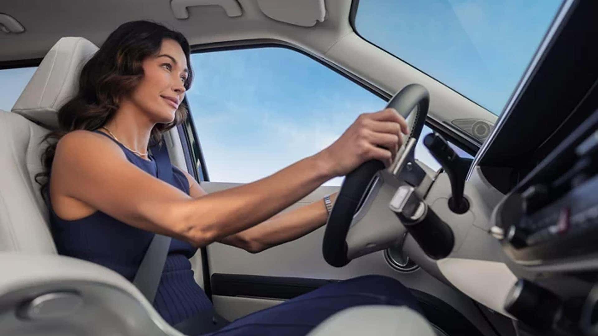 2026 Hyundai Palisade Hybrid driving on a highway, showcasing smooth acceleration from its turbocharged hybrid powertrain.