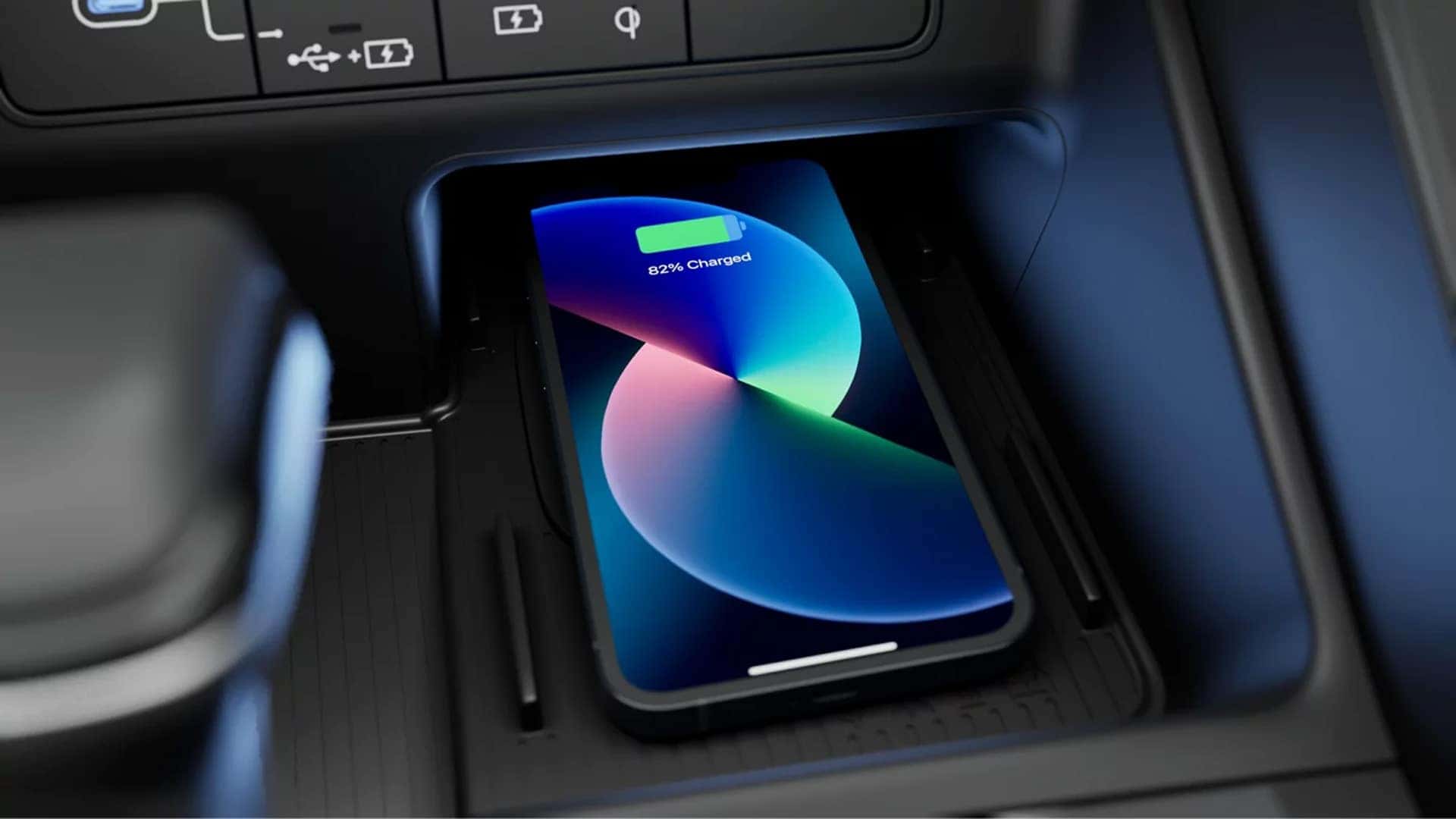 Wireless smartphone charging pad in the 2026 Hyundai Santa Cruz center console with a device charging inside the tray