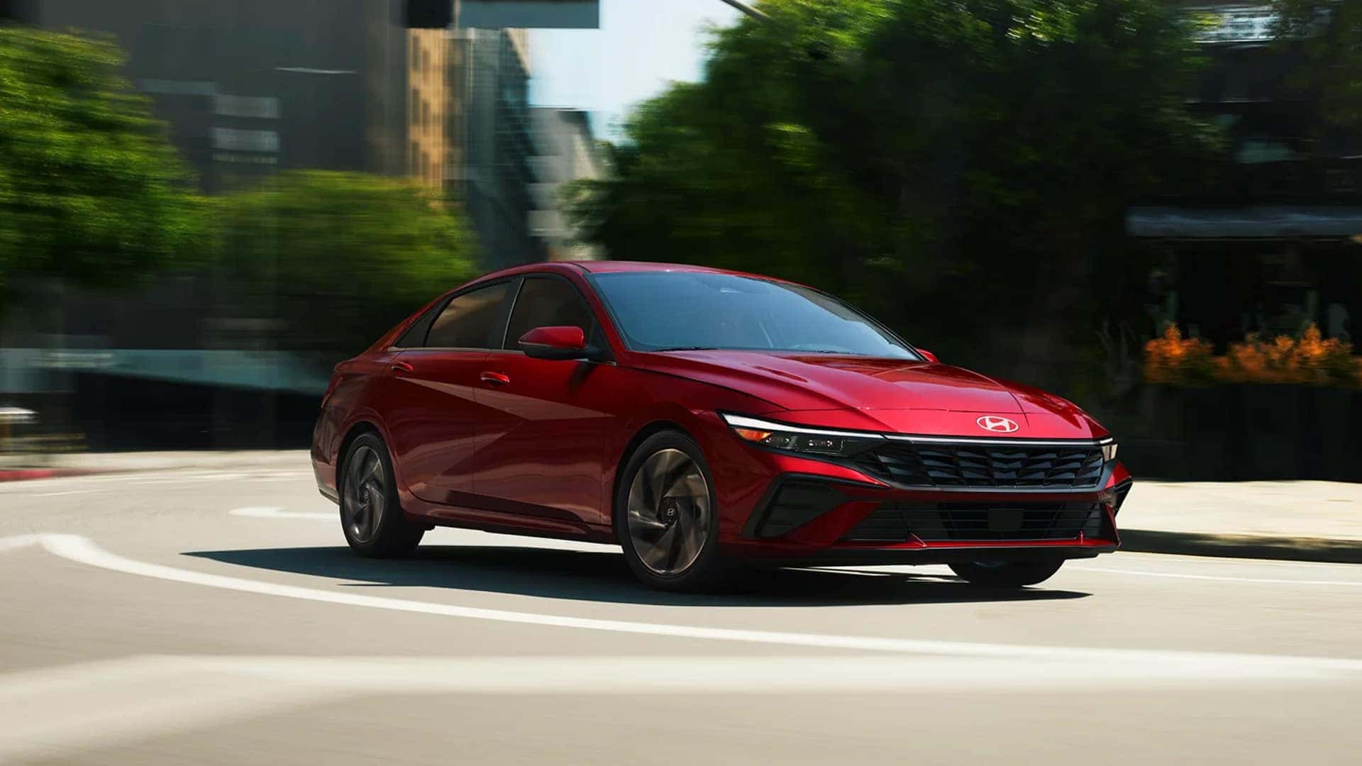 2026 Hyundai Elantra driving through a city street demonstrating smooth performance and handling